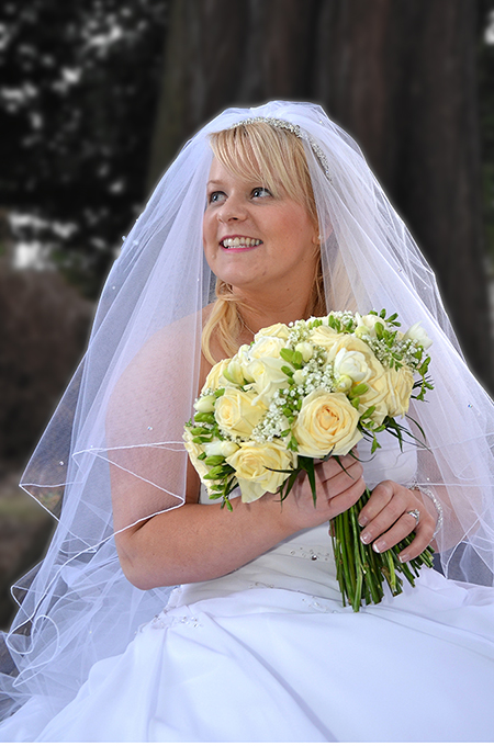 Relaxed bride portrait in the garden of Scottish hotel by wedding photographer Alexander Whyte